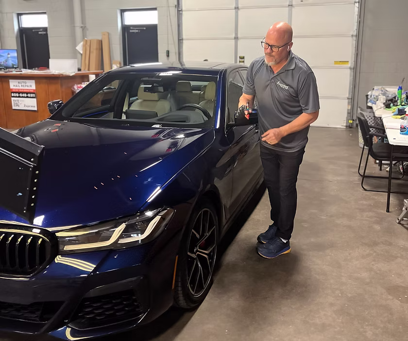A vehicle being restored after hail damage by Express Hail Repair technicians